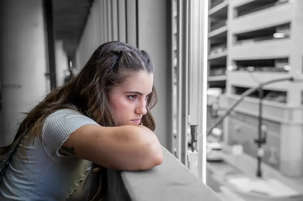 Woman looking out of a parking garage in ft. worth texas.