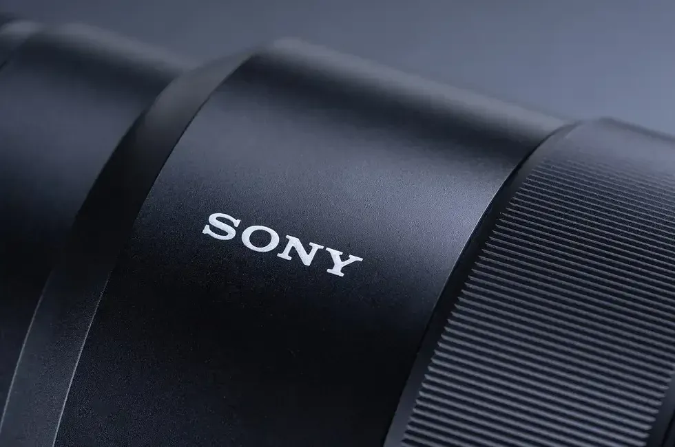 Close-up of a black Sony camera lens with the Sony logo.